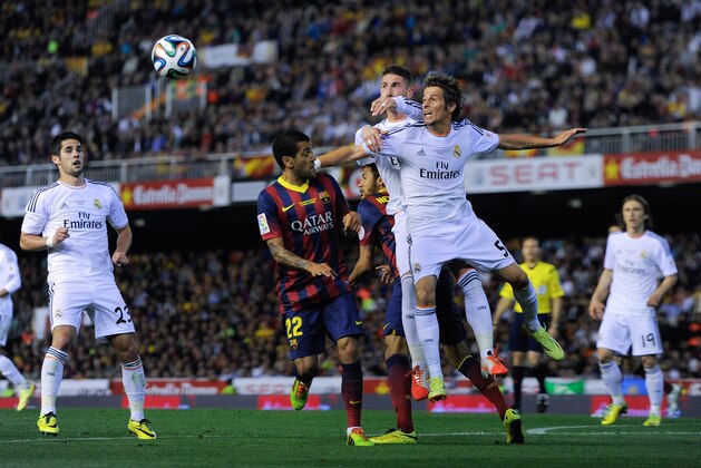 VALENCIA, SPAIN - APRIL 16:  Fabio Coentrao of Real Madrid CF and Sergio Ramos of Real Madrid CF duel for a high ball with Dani Alves of FC Barcelona during the Copa del Rey Final between Real Madrid and FC Barcelona at Estadio Mestalla on April 16, 2014 in Valencia, Spain.  (Photo by David Ramos/Getty Images)