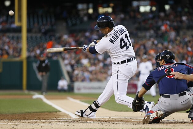 Detroit Tigers' Victor Martinez (41) hits a two-run home run off Minnesota Twins pitcher Trevor May in the first inning of a baseball game in Detroit, Thursday, Sept. 25, 2014. (AP Photo/Paul Sancya)