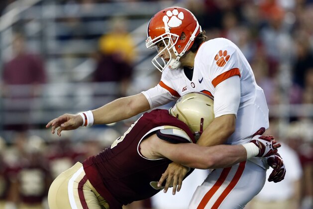 Oct 18, 2014; Boston, MA, USA; Clemson Tigers quarterback Cole Stoudt (18) is tackled by Boston College Eagles defensive end Kevin Kavalec (left) during the second half at Alumni Stadium. Mandatory Credit: Mark L. Baer-USA TODAY Sports