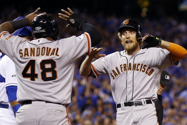 San Francisco Giants' Hunter Pence is congratulated by Pablo Sandoval after Pence hit a two-run home run during the first inning of Game 1 of baseball's World Series against the Kansas City Royals Tuesday, Oct. 21, 2014, in Kansas City, Mo. (AP Photo/David J. Phillip)
