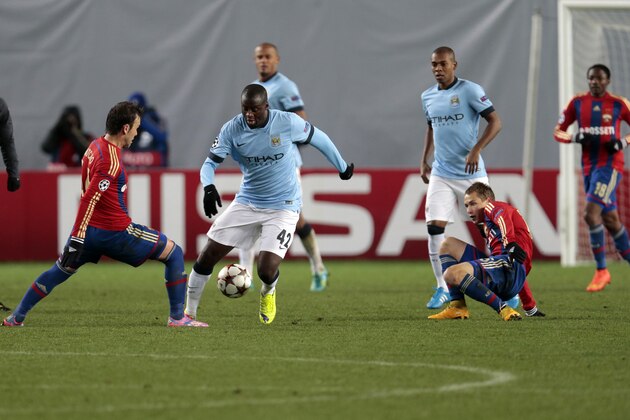 Manchester City's Yaya Toure, second left, battles for the ball with CSKA's Bebras Natcho, left, during the Champions League Group E soccer match between CSKA Moscow and Manchester City at Arena Khimki stadium in Moscow, Russia, Tuesday Oct. 21, 2014. (AP Photo/Ivan Sekretarev)