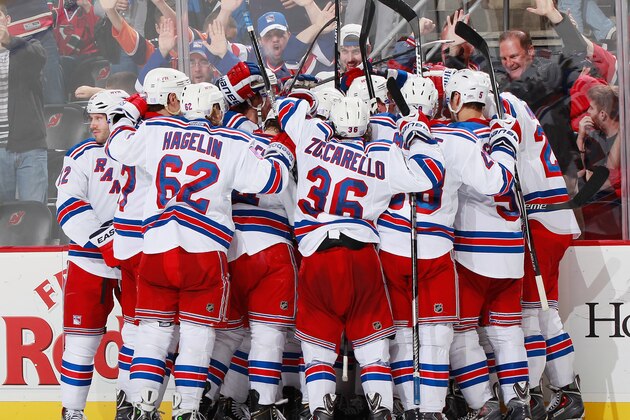 NEWARK, NJ - OCTOBER 21: The New York Rangers celebrate their overtime victory against the New Jersey Devils during the game at the Prudential Center on October 21, 2014 in Newark, New Jersey. The Rangers defeated the devils 4-3. (Photo by Andy Marlin/NHLI via Getty Images)