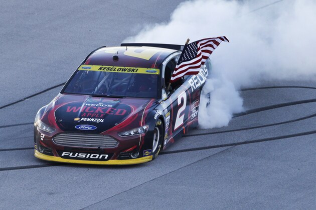 Brad Keselowski celebrates after winning the  NASCAR Sprint Cup Series auto race at Talladega Superspeedway Sunday, Oct. 19, 2014, in Talladega, Ala.   (AP Photo/Butch Dill)