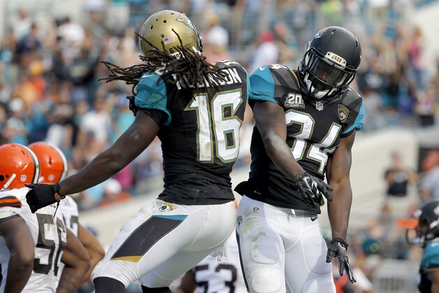 Jacksonville Jaguars running back Denard Robinson (16) and Jacksonville Jaguars running back Storm Johnson (34) celebrate Johnson's touchdown during the second half of an NFL football game against the Cleveland Browns, Sunday, Oct. 19, 2014, in Jacksonville, Fla. The Jaguars beat the Browns 24-6. (AP Photo/Stephen B. Morton)