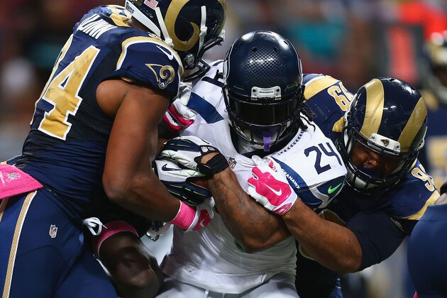ST. LOUIS, MO - OCTOBER 19: Marshawn Lynch #24 of the Seattle Seahawks is tackled by Aaron Donald #99 and Robert Quinn #94 of the St. Louis Rams int he third quarter at the Edward Jones Dome on October 19, 2014 in St. Louis, Missouri.  The Rams beat the Seahawks 28-26.  (Photo by Dilip Vishwanat/Getty Images)