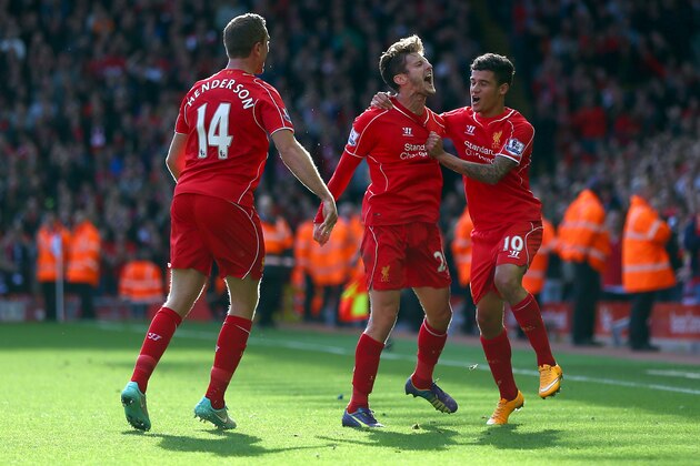 LIVERPOOL, ENGLAND - OCTOBER 04: Adam Lallana of Liverpool is congratulated by Philippe Coutinho (R) and Jordan Henderson of Liverpool (L) on scoring the opening goal during the Barclays Premier League match between Liverpool and West Bromwich Albion at Anfield on October 4, 2014 in Liverpool, England.  (Photo by Clive Brunskill/Getty Images)