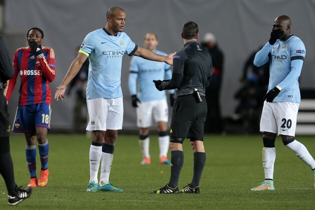 Manchester City's Vincent Kompany, second left, talks to the referee during the Champions League Group E soccer match between CSKA Moscow and Manchester City at Arena Khimki stadium in Moscow, Russia, Tuesday Oct. 21, 2014. (AP Photo/Ivan Sekretarev)