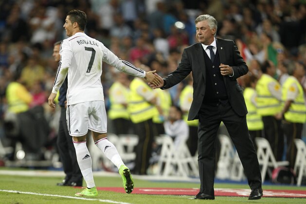 Real's Cristiano Ronaldo, left, celebrates his fourth goal with Real's Carlo Ancelotti, right,  during a Spanish La Liga soccer match between Real Madrid and Elche at the Santiago Bernabeu stadium in Madrid, Spain, Tuesday, Sept. 23, 2014. (AP Photo/Andres Kudacki)