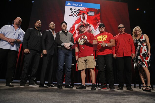 SummerSlam Confidential Panel participants pose for a photo after announcing the WWE 2K15 roster. From left to right: WWE Hall of Famer Stone Cold Steve Austin, WWE Superstars Roman Reigns, Cesaro, Sheamus and John Cena, WWE Hall of Famer Hulk Hogan,  iconic competitor Sting and WWE broadcaster Renee Young at Club Nokia, on Saturday, August 16, 2014 in Los Angeles. (Photo by Todd Williamson/Invision for 2K/AP Images)