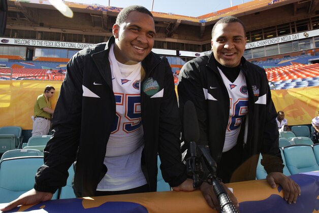 FILE - In this Jan. 5, 2009 file photo, University of Florida teammates and twin brothers Mike, left, and Maurkice Pouncey smiles during media day at Dolphins Stadium in Miami. Pittsburgh Steelers All-Pro center Maurkice Pouncey has apologized for wearing a baseball cap supporting former college teammate Aaron Hernandez. Pouncey and his twin brother Mike, a center for the Miami Dolphins, were photographed wearing hats that read