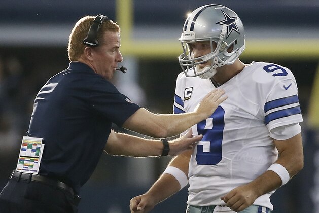 Dallas Cowboys head coach Jason Garrett gives quarterback Tony Romo (9) instructions during the second half of an NFL football game against the New York Giants, Sunday, Oct.  19, 2014, in Arlington, Texas. (AP Photo/Brandon Wade)