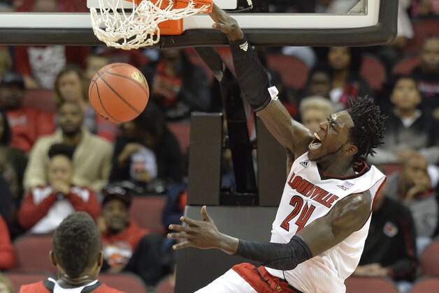 Louisville's Montrezl Harrell, right, dunks as Louisville's Chinanu Onuaku looks on during the first half of an NCAA college basketball scrimmage Sunday, Oct. 19, 2014, in Louisville, Ky. (AP Photo/Timothy D. Easley)