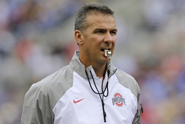 Ohio State head coach Urban Meyer watches his team warm up before an NCAA college football game against Navy in Baltimore, Saturday, Aug. 30, 2014. (AP Photo/Patrick Semansky)