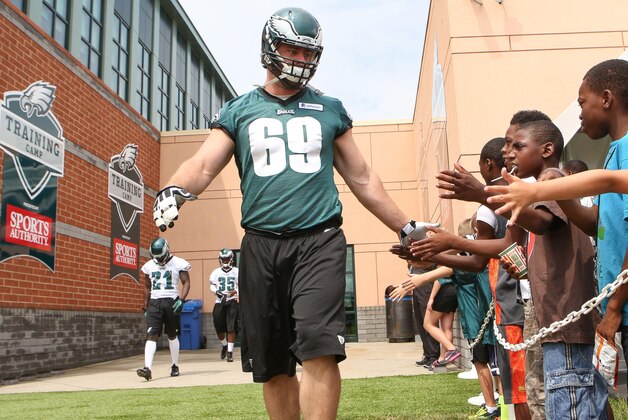 Jul 26, 2014; Philadelphia, PA, USA; Philadelphia Eagles guard Evan Mathis (69) is greeted by fans as he runs onto the field for the start of training camp at the Novacare Complex. Mandatory Credit: Bill Streicher-USA TODAY Sports