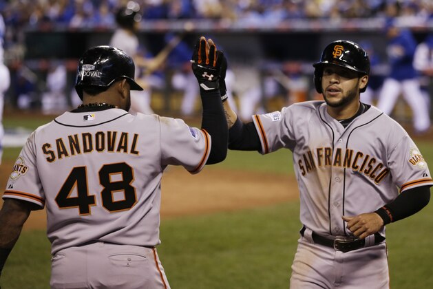 San Francisco Giants' Gregor Blanco is congratulated by teammate Pablo Sandoval (48) after scoring on an RBI triple by San Francisco Giants second baseman Joe Panik during the seventh inning of Game 1 of baseball's World Series Tuesday, Oct. 21, 2014, in Kansas City, Mo. (AP Photo/Matt Slocum )