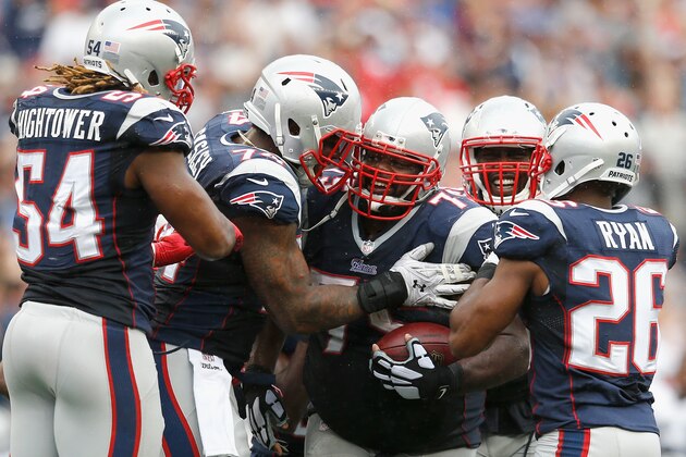 FOXBORO, MA - SEPTEMBER 21:  Vince Wilfork #75 of the New England Patriots celebrates with teammates after intercepting the ball during the fourth quarter against Oakland Raiders at Gillette Stadium on September 21, 2014 in Foxboro, Massachusetts.  (Photo by Jim Rogash/Getty Images)