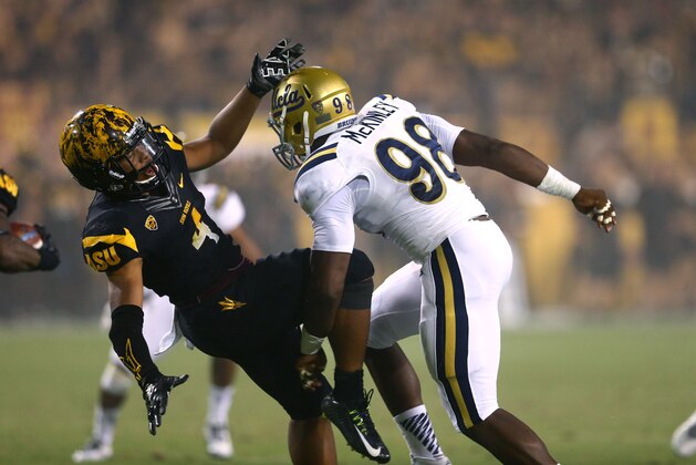Sep 25, 2014; Tempe, AZ, USA; UCLA Bruins defensive lineman Takkarist McKinley (98) hits Arizona State Sun Devils running back Demario Richard at Sun Devil Stadium. Mandatory Credit: Mark J. Rebilas-USA TODAY Sports