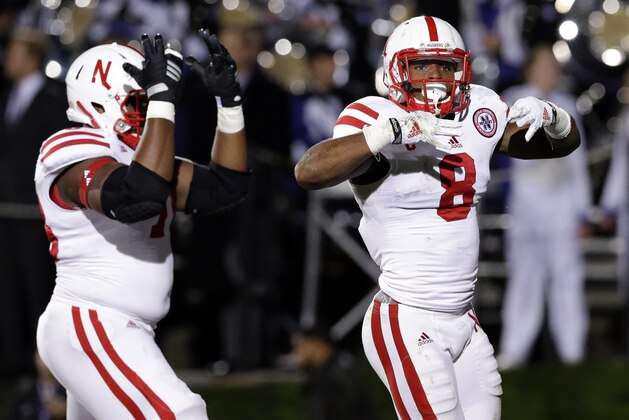 Nebraska running back Ameer Abdullah (8) and offensive line Givens Price (78) celebrate after Abdullah scored a touchdown during the first half of an NCAA college football game against Northwestern in Evanston, Ill., Saturday, Oct. 18, 2014. (AP Photo/Nam Y. Huh)