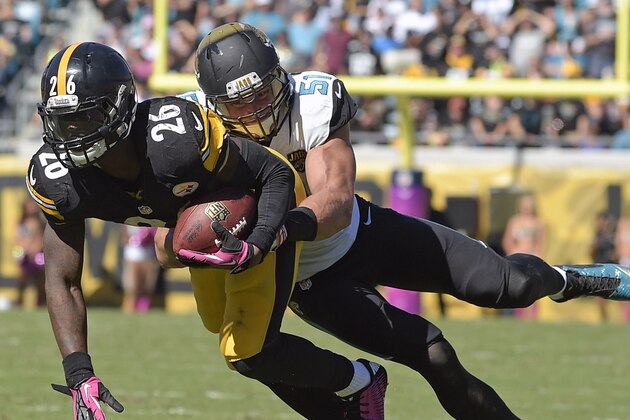 In this Oct. 5, 2014 file photo, Pittsburgh Steelers running back Le'Veon Bell (26) is stopped by Jacksonville Jaguars middle linebacker Paul Posluszny (51) after a short gain during the second half of an NFL football game in Jacksonville, Fla. Posluszny tore a pectoral muscle in his chest during Sunday's 24-6 win against Cleveland and will be out for the rest of the season. (AP Photo/Phelan M. Ebenhack)