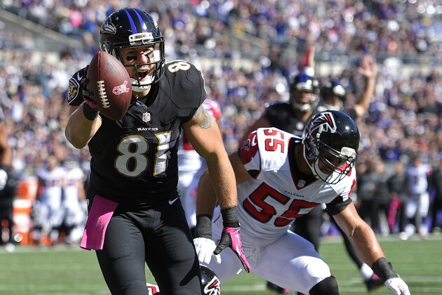Baltimore Ravens tight end Owen Daniels, left, scores a touchdown in front of Atlanta Falcons inside linebacker Paul Worrilow in the first half of an NFL football game, Sunday, Oct. 19, 2014, in Baltimore. (AP Photo/Nick Wass)