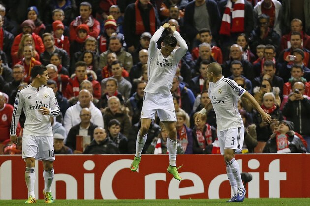 Real Madrid's Cristiano Ronaldo, centre, celebrates after scoring the opening goal during the Champions League group B soccer match between Liverpool and Real Madrid at Anfield Stadium, Liverpool, England, Wednesday Oct. 22, 2014. (AP Photo/Jon Super)