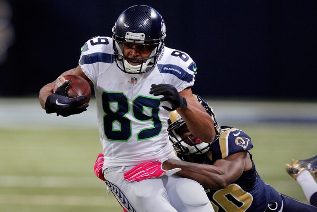 Oct 19, 2014; St. Louis, MO, USA; Seattle Seahawks wide receiver Doug Baldwin (89) is tackled by St. Louis Rams cornerback Lamarcus Joyner (20) during the first half of a football game  at the Edward Jones Dome. Mandatory Credit: Scott Kane-USA TODAY Sports