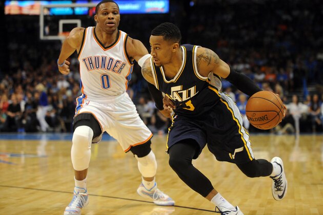Oct 21, 2014; Oklahoma City, OK, USA Utah Jazz guard Trey Burke (3) handles the ball in front of Oklahoma City Thunder guard Russell Westbrook (0) during the first quarter at Chesapeake Energy Arena. Mandatory Credit: Mark D. Smith-USA TODAY Sports