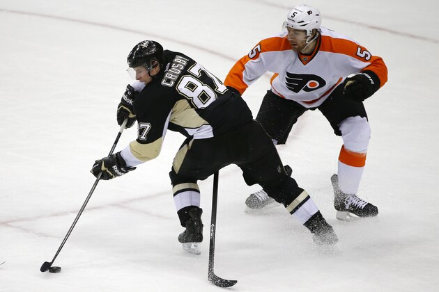 Pittsburgh Penguins' Sidney Crosby (87) backhands a pass in front of Philadelphia Flyers' Braydon Coburn (5) in the third period of an NHL hockey game in Pittsburgh, Saturday, April 12, 2014. (AP Photo/Gene J. Puskar)
