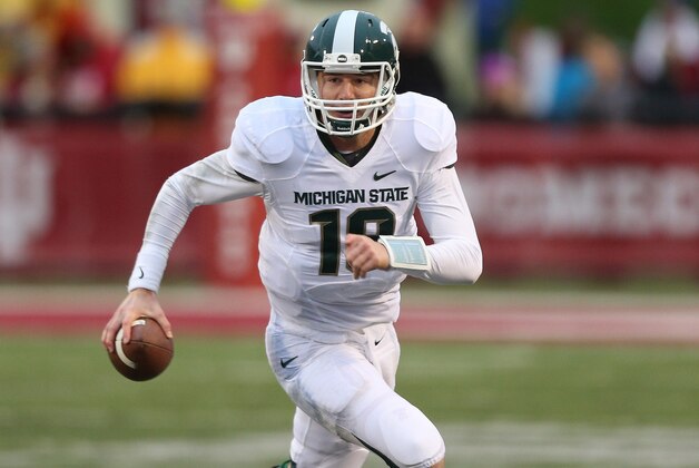 Oct 18, 2014; Bloomington, IN, USA; Michigan State Spartans quarterback Connor Cook (18) rolls out of the pocket as the looks to pass against the Indiana Hoosiers at Memorial Stadium. Mandatory Credit: Brian Spurlock-USA TODAY Sports