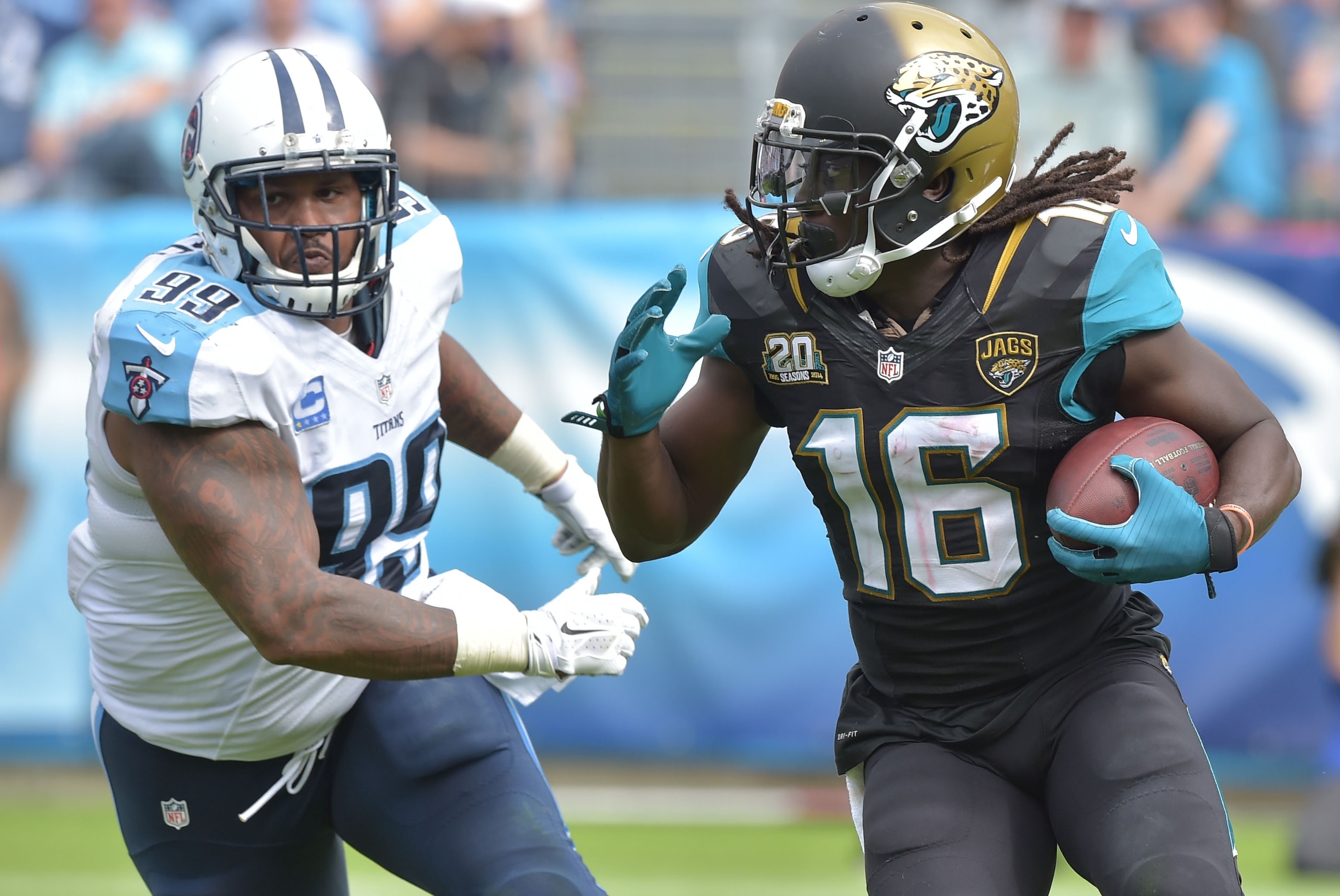 Oct 12, 2014; Nashville, TN, USA; Jacksonville Jaguars wide receiver Denard Robinson (16) carries the ball against Tennessee Titans defensive tackle Jurrell Casey (99) during the second half at LP Field. The Titans beat the Jaguars 16-14. Mandatory Credit: Don McPeak-USA TODAY Sports