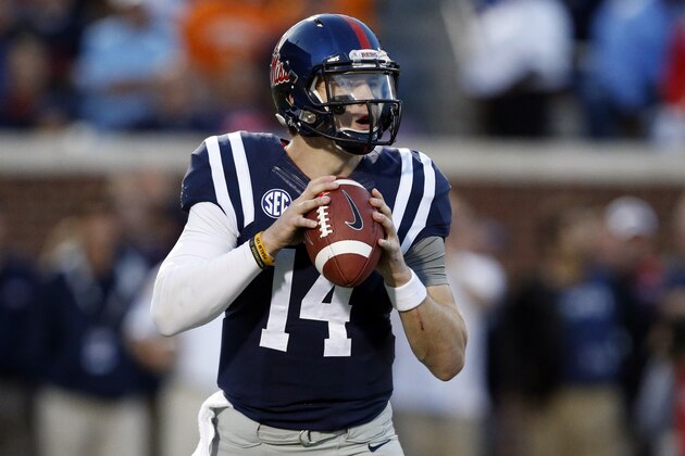 Mississippi quarterback Bo Wallace (14) drops back to pass against Tennessee in the first half of an NCAA college football game in Oxford, Miss., Saturday, Oct. 18, 2014. (AP Photo/Rogelio V. Solis)