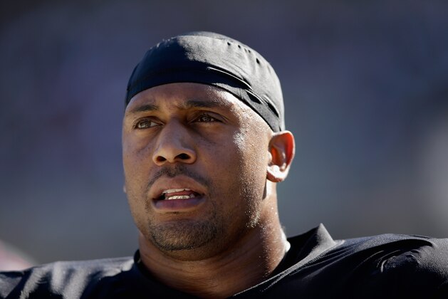 OAKLAND, CA - OCTOBER 12:  LaMarr Woodley #58 of the Oakland Raiders stands on the sidelines during their game against the San Diego Chargers at O.co Coliseum on October 12, 2014 in Oakland, California.  (Photo by Ezra Shaw/Getty Images)