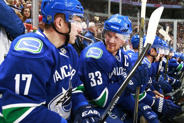 VANCOUVER, BC - OCTOBER 11: Radim Vrbata #17 of the Vancouver Canucks talks to teammate Henrik Sedin #33 during their NHL game against the Edmonton Oilers at Rogers Arena October 11, 2014 in Vancouver, British Columbia, Canada.  Vancouver won 5-4 in a shootout. (Photo by Jeff Vinnick/NHLI via Getty Images)