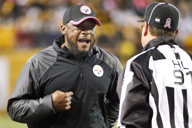 Pittsburgh Steelers head coach Mike Tomlin, left, disagrees with Head Linesman Jerry Bergman (91) during the second half of the NFL football game against the Houston Texans, Monday, Oct. 20, 2014 in Pittsburgh. (AP Photo/Gene J. Puskar)