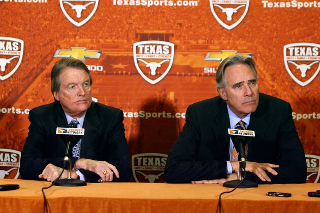 AUSTIN, TX - DECEMBER 15: University of Texas at Austin president Bill Powers, left, and Athletic Director Steve Patterson answer questions regarding the resignation of football coach Mack Brown on December 15, 2013 in Austin, Texas. Moments earlier, Brown announced he will step down as coach after the Valero Alamo Bowl game against Oregon on December 30. (Photo by Erich Schlegel/Getty Images)