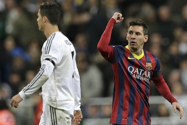 FC Barcelona's Lionel Messi from Argentina, right celebrates next to Real Madrid's Cristiano Ronaldo after scoring his team's 2nd goal during a Spanish La Liga soccer match at the Santiago Bernabeu stadium in Madrid, Sunday March 23, 2014. (AP Photo/Paul White) FC Barcelona's Lionel Messi from Argentina, right celebrates next to Real Madrid's Cristiano Ronaldo after scoring his team's 2nd goal during a Spanish La Liga soccer match at the Santiago Bernabeu stadium in Madrid, Sunday March 23, 2014. (AP Photo/Paul White)