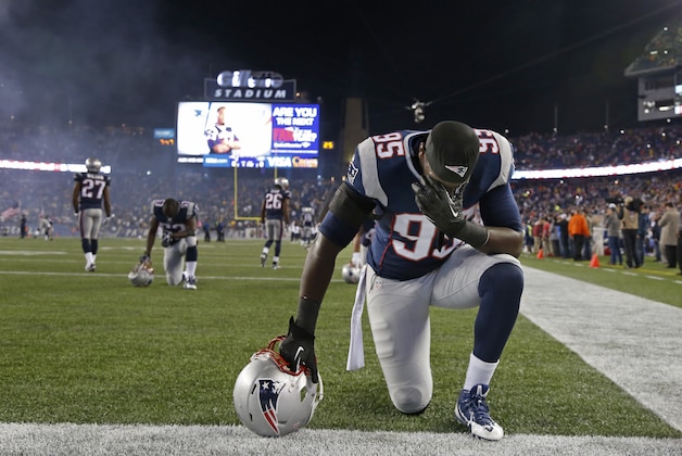 New England Patriots defensive end Chandler Jones (95) takes a moment before an NFL football game against the New York Jets, Thursday, Oct. 16, 2014, in Foxborough, Mass. (AP Photo/Elise Amendola)