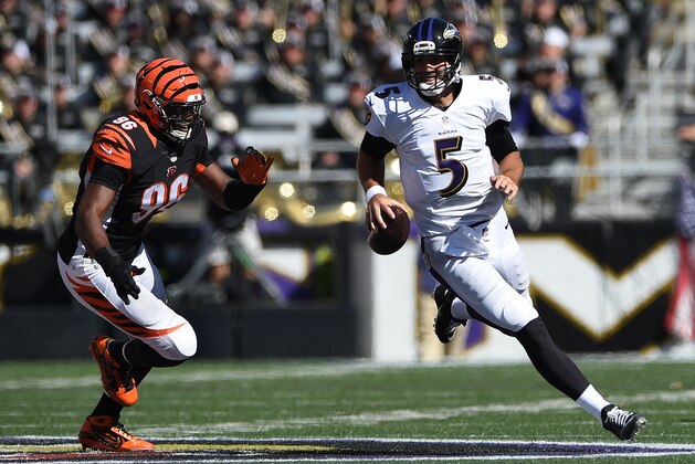 BALTIMORE, MD - SEPTEMBER 07: Quarterback Joe Flacco #5 of the Baltimore Ravens rushes past defensive end Carlos Dunlap #96 of the Cincinnati Bengals in the fourth quarter M&T Bank Stadium on September 7, 2014 in Baltimore, Maryland. The Cincinnati Bengals won, 23-16. (Photo by Patrick Smith/Getty Images)