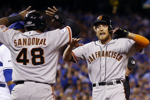 San Francisco Giants' Hunter Pence is congratulated by Pablo Sandoval after Pence hit a two-run home run during the first inning of Game 1 of baseball's World Series against the Kansas City Royals Tuesday, Oct. 21, 2014, in Kansas City, Mo. (AP Photo/David J. Phillip)