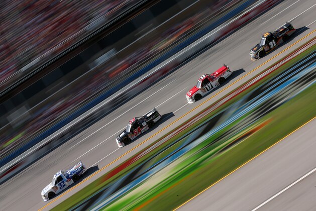 TALLADEGA, AL - OCTOBER 18: Tayler Malsam, driver of the #32 Outerwall Chevrolet, leads a pack of trucks during the NASCAR Camping World Series Fred's 250 Powered by Coca-Cola at Talladega Superspeedway on October 18, 2014 in Talladega, Alabama.  (Photo by Mike Ehrmann/Getty Images)