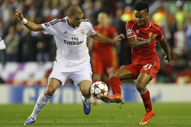 Real Madrid's Pepe, left, challenges Liverpool's Raheem Sterling during the Champions League group B soccer match between Liverpool and Real Madrid at Anfield Stadium, Liverpool, England, Wednesday Oct. 22, 2014. (AP Photo/Jon Super)