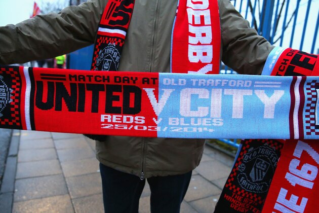 MANCHESTER, ENGLAND - MARCH 25:  A vendor sells match scarves prior to the Barclays Premier League match between Manchester United and Manchester City at Old Trafford on March 25, 2014 in Manchester, England.  (Photo by Alex Livesey/Getty Images)