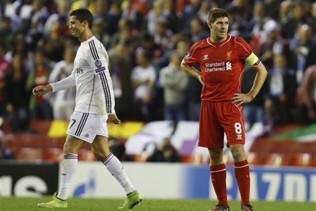 Real Madrid's Cristiano Ronaldo, left, walks past Liverpool's Steven Gerrard after Karim Benzema scored his side's third goal during the Champions League group B soccer match between Liverpool and Real Madrid at Anfield Stadium, Liverpool, England, Wednesday Oct. 22, 2014. (AP Photo/Jon Super)