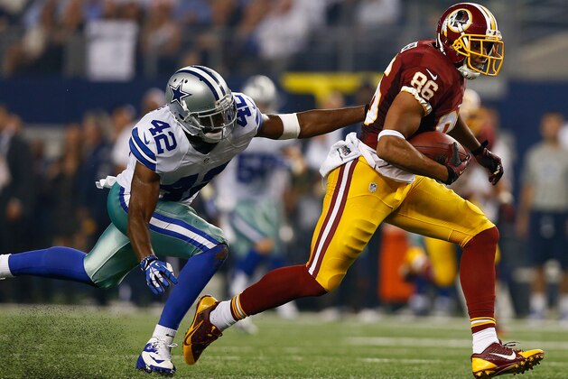 ARLINGTON, TX - OCTOBER 13:   Jordan Reed #86 of the Washington Redskins carries the ball against  Barry Church #42 of the Dallas Cowboys at AT&T Stadium on October 13, 2013 in Arlington, Texas.  (Photo by Tom Pennington/Getty Images)