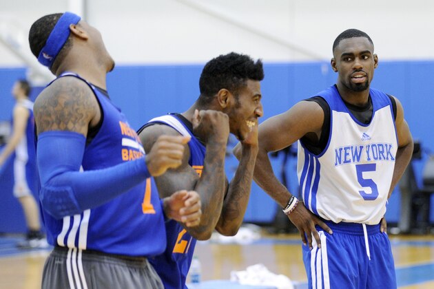 New York Knicks' Tim Hardaway, Jr. (5) looks on as Iman Shumpert and Carmelo Anthony, left, react to their shooting drill at the teams NBA basketball training camp Tuesday, Oct. 1, 2013, in Greenburgh, N.Y. (AP Photo/Bill Kostroun)