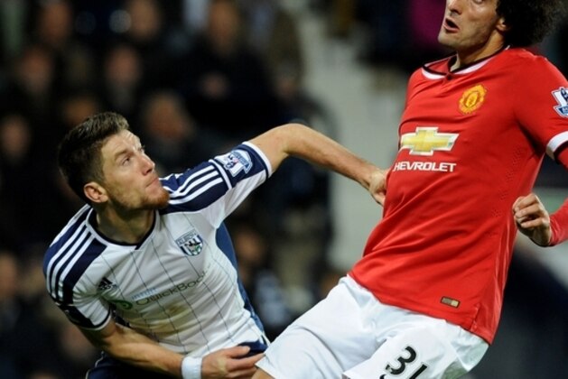 Manchester United's Marouane Fellaini, right, battles for the ball with West Bromwich Albion's Sebastien Pocognoli during the English Premier League soccer match between West Bromwich Albion and Manchester United at the Hawthorns, Birmingham, England, Monday, Oct. 20, 2014. (AP Photo/Rui Vieira)