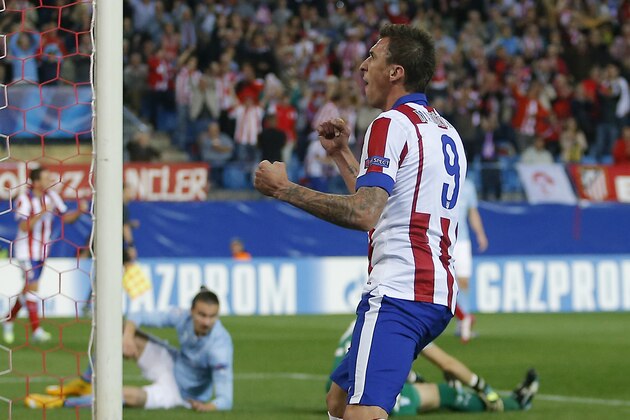 Atletico's Mario Mandzukic celebrates after scoring during the Group A Champions League soccer match between Atletico de Madrid and Malmo at the Vicente Calderon stadium in Madrid, Spain, Wednesday, Oct. 22, 2014. (AP Photo/Andres Kudacki)