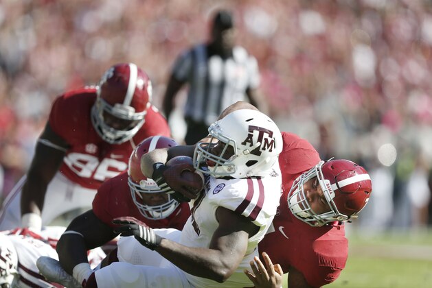 Alabama linebacker Ryan Anderson, right, sacks Texas A&M quarterback Kenny Hill during the first half of an NCAA college football game on Saturday, Oct, 18, 2014, in Tuscaloosa, Ala. (AP Photo/Brynn Anderson)