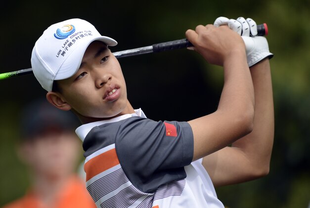 Apr 14, 2013; Augusta, GA, USA; Tianlang Guan hits his tee shot on the 7th hole during the final round of the 2013 The Masters golf tournament at Augusta National Golf Club.  Mandatory Credit: Jack Gruber-USA TODAY Sports