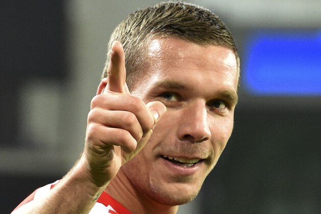 Arsenal's Lukas Podolski gestures to fans after the Group D Champions League match between Anderlecht and Arsenal at Constant Vanden Stock Stadium in Brussels, Belgium, Wednesday Oct. 22, 2014. Arsenal won the match with a 2-1 score, Podolski scored his team's second goal. (AP Photo/Geert Vanden Wijngaert)